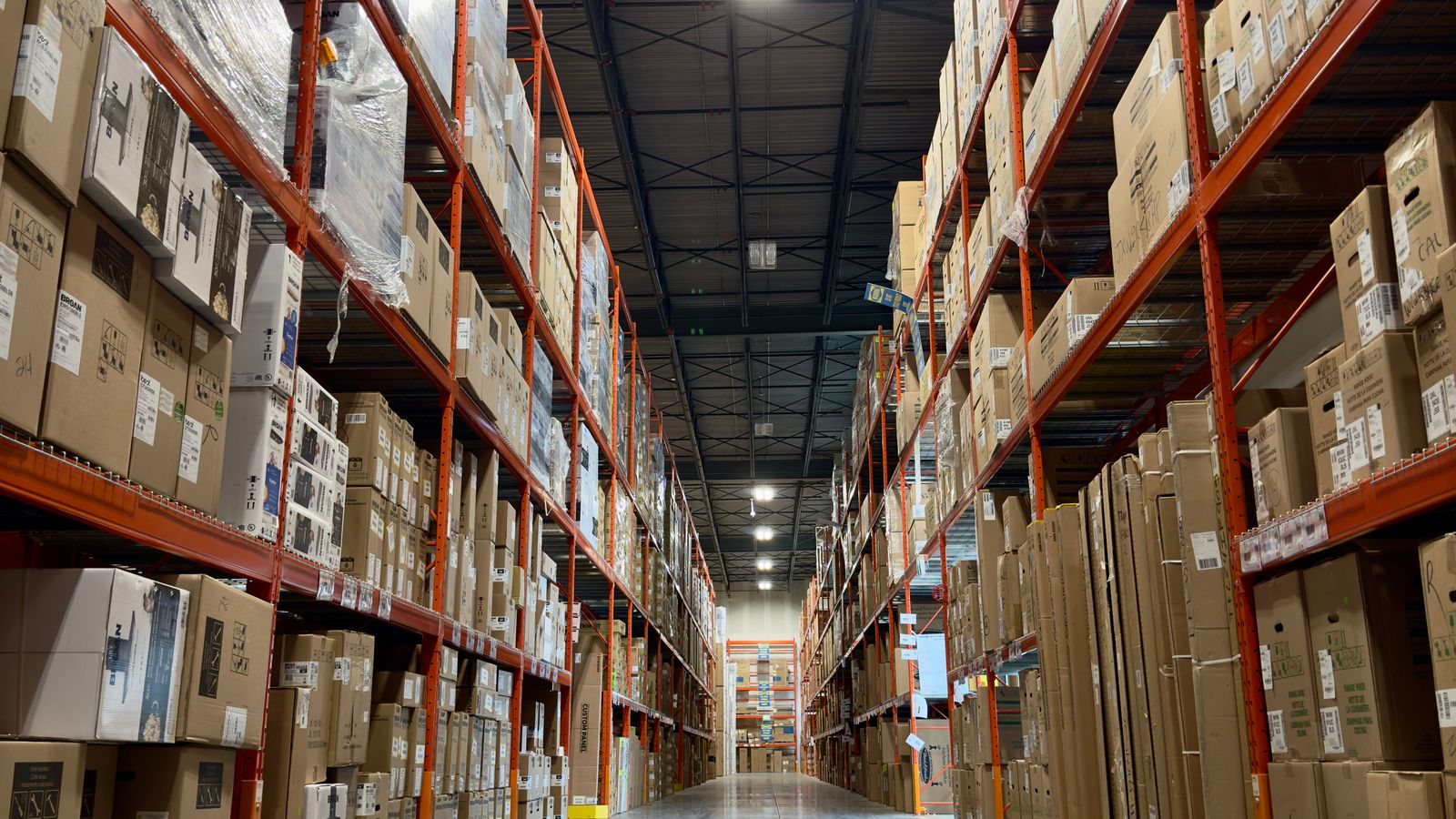 Warehouse aisle with pallet racking loaded with boxes